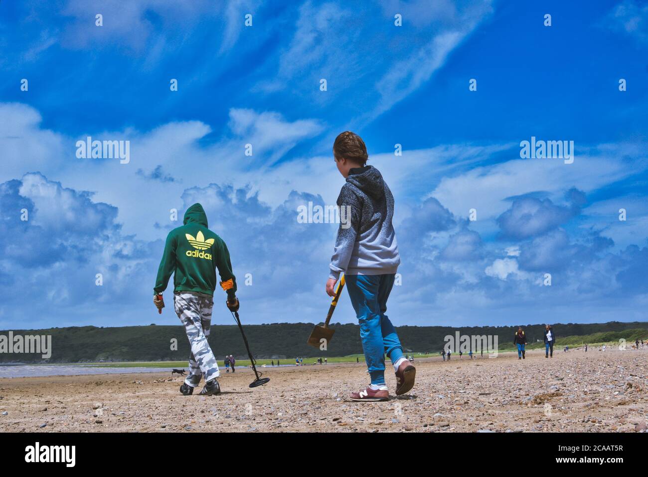 Metal detecting on the beach Stock Photo Alamy