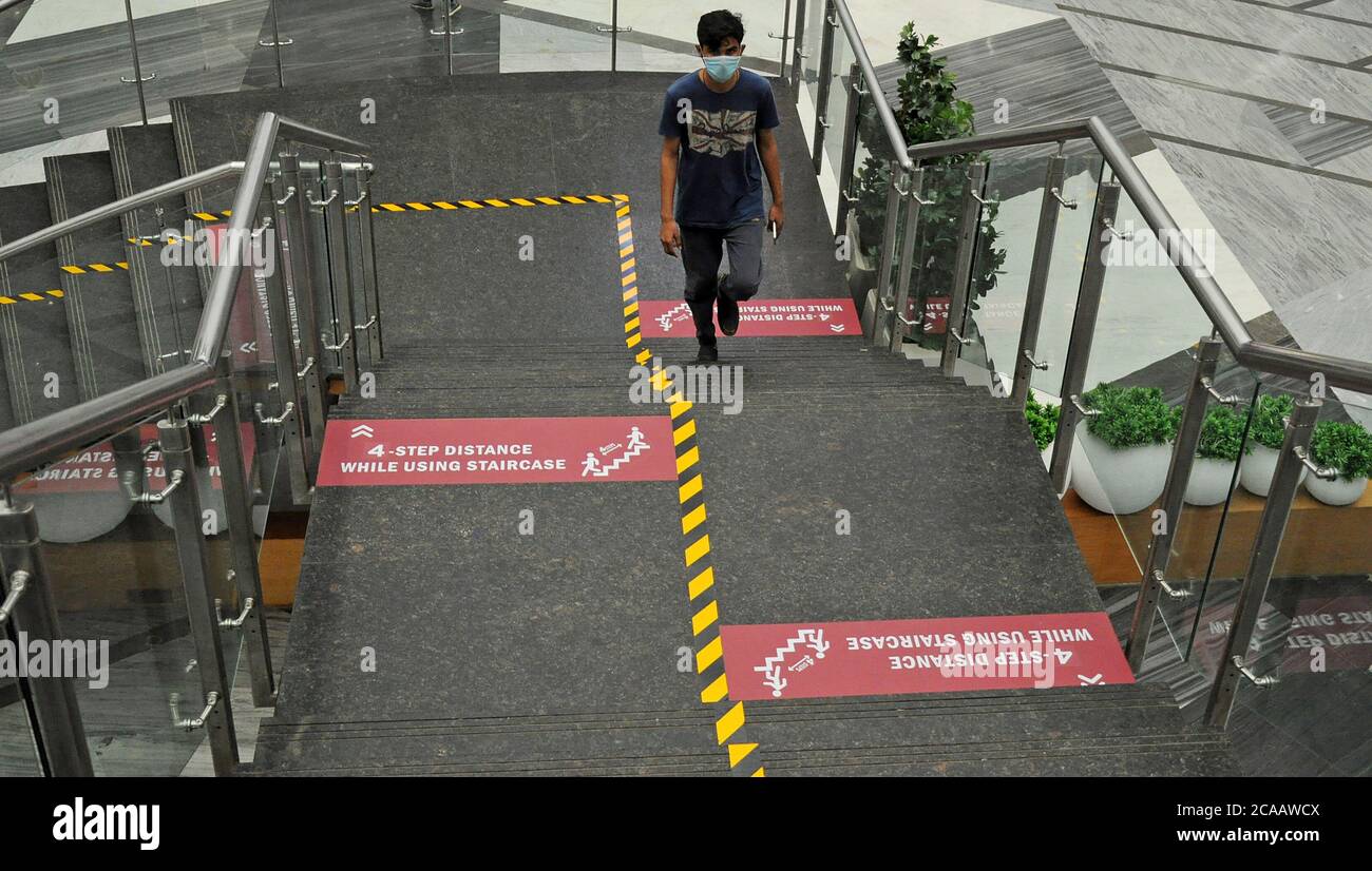 Social distancing signs on stairs inside a mall during the reopening