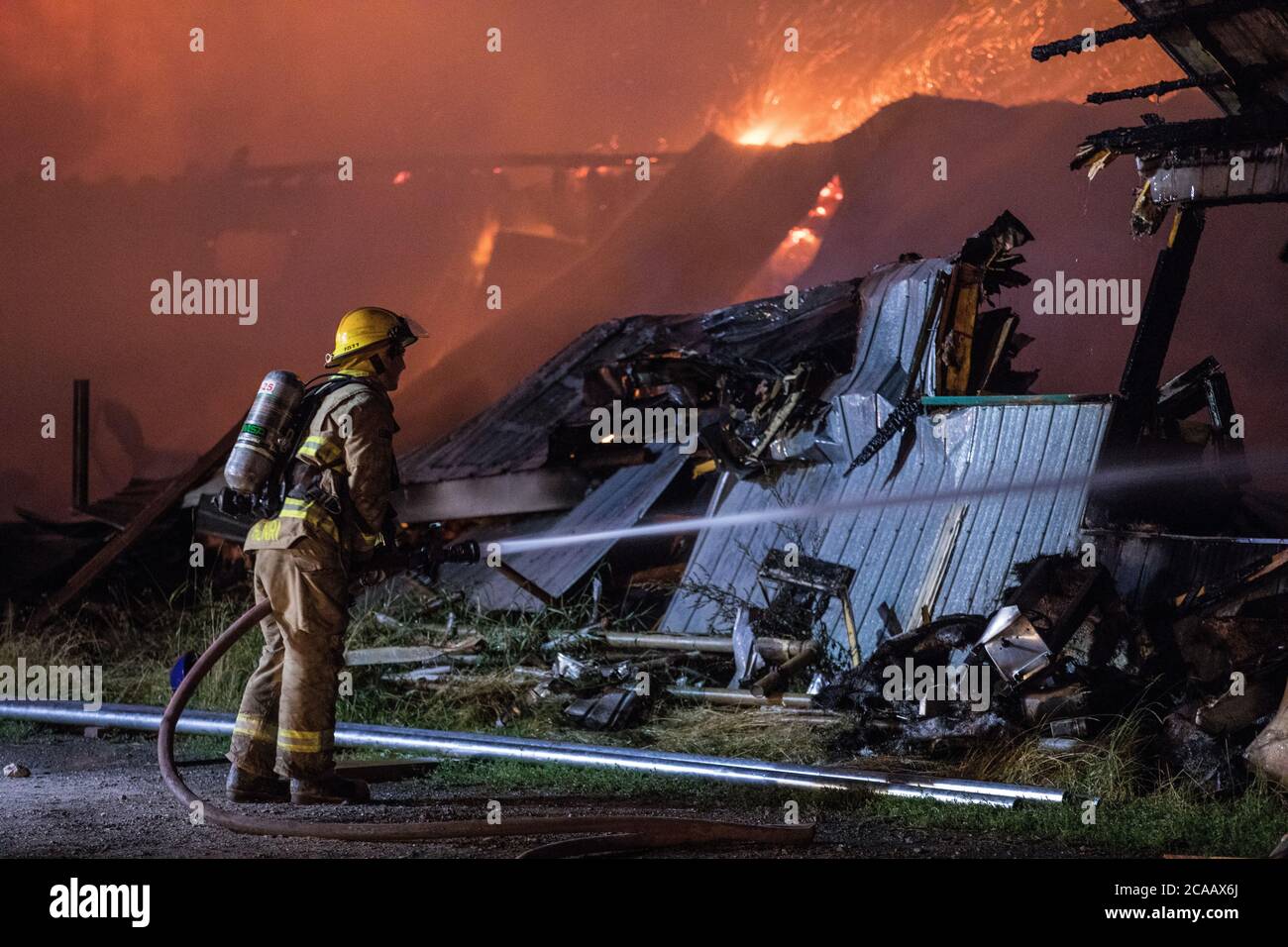 Firefighter battle house fire Stock Photo Alamy