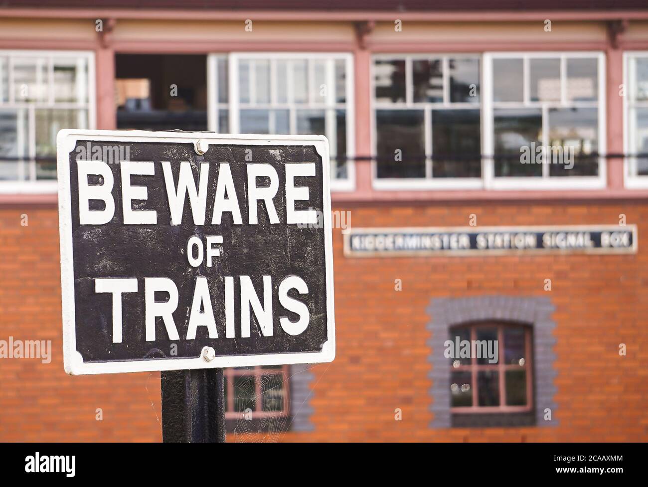 Vintage railway sign Beware of Trains & vintage signal box, Severn Valley heritage railway station, Kidderminster, UK. Stock Photo