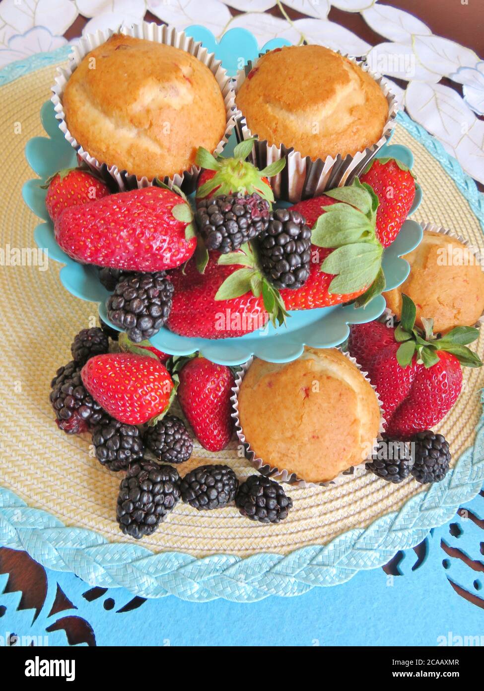 Fresh baked muffins with blueberries and strawberries Stock Photo