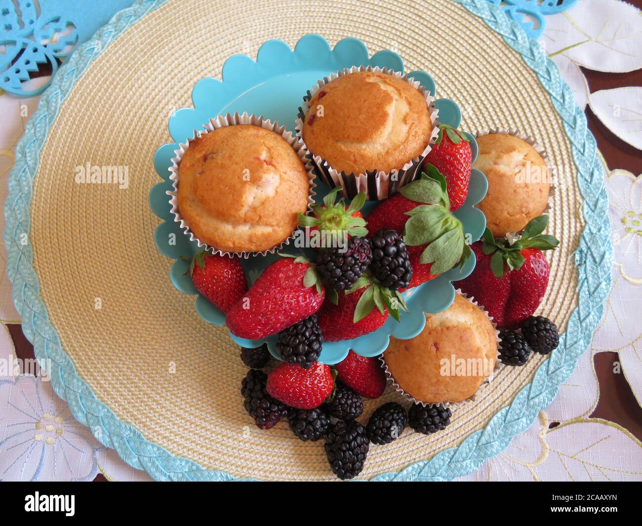 Fresh baked muffins with blueberries and strawberries Stock Photo