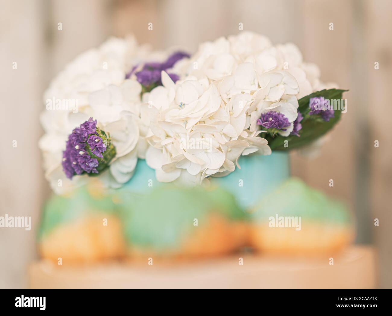 White Hydrangeas Decorated with Pastel Green Cream Puffs. Stock Photo
