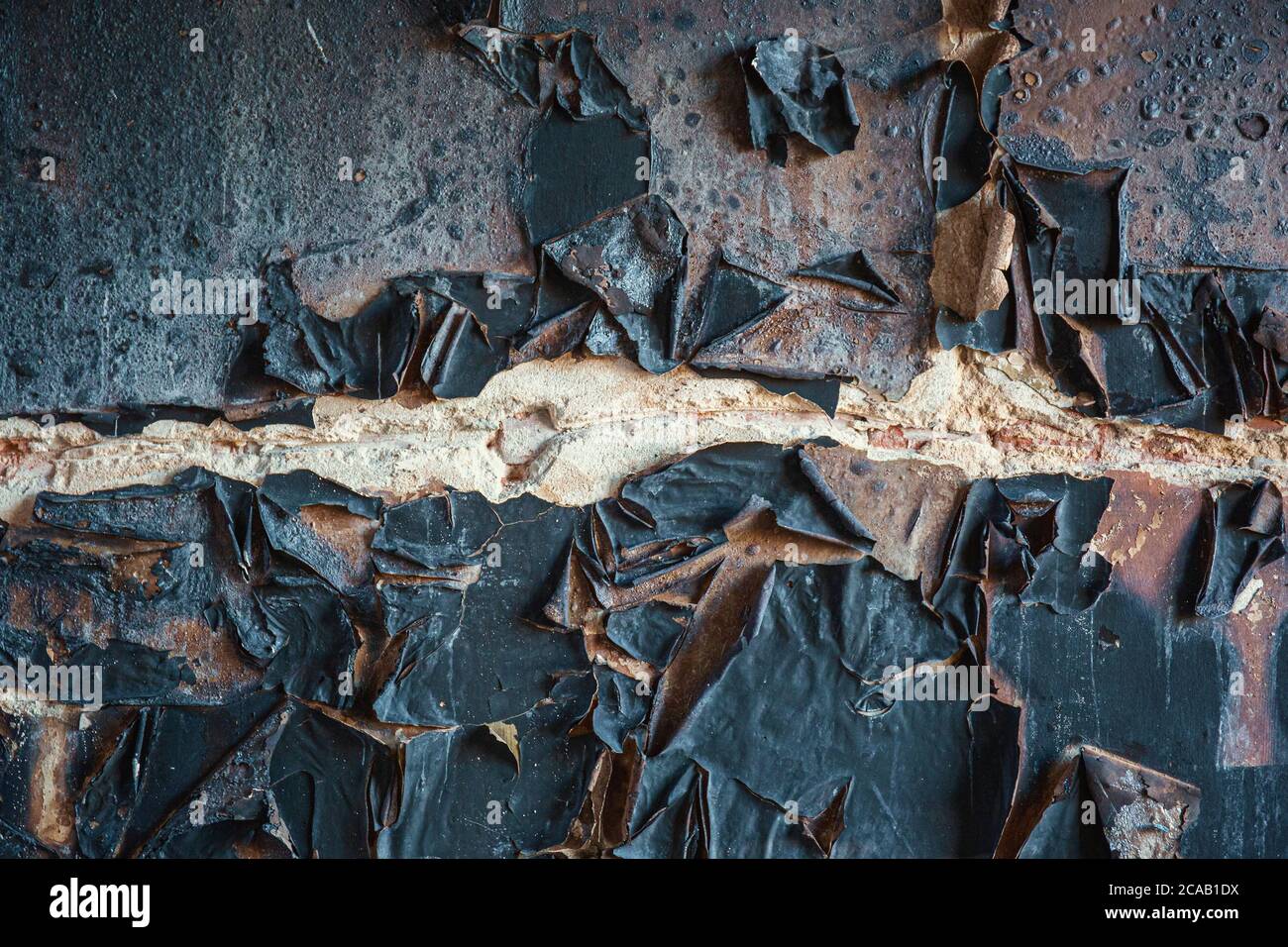 Burnt wall texture background. Burned house after fire wall surface with coal. Stock Photo