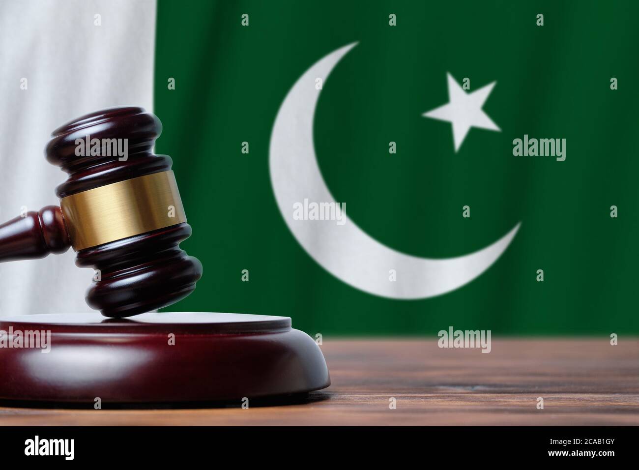 Justice and court concept in Islamic Republic of Pakistan. Judge hammer on a flag background. Stock Photo