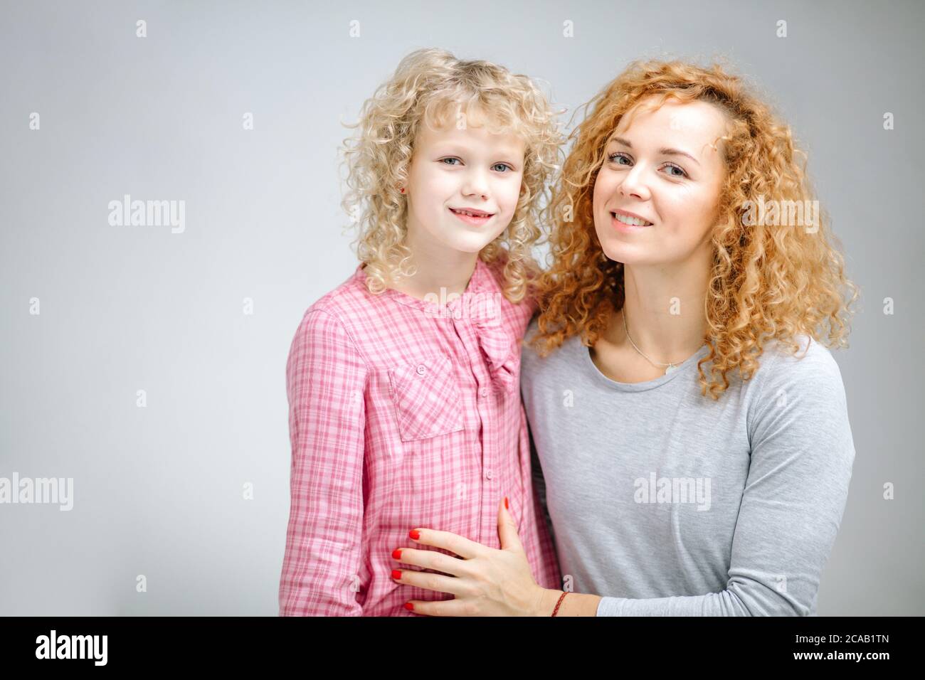 awesome mother with her adorable child looking at the camera m studio ...