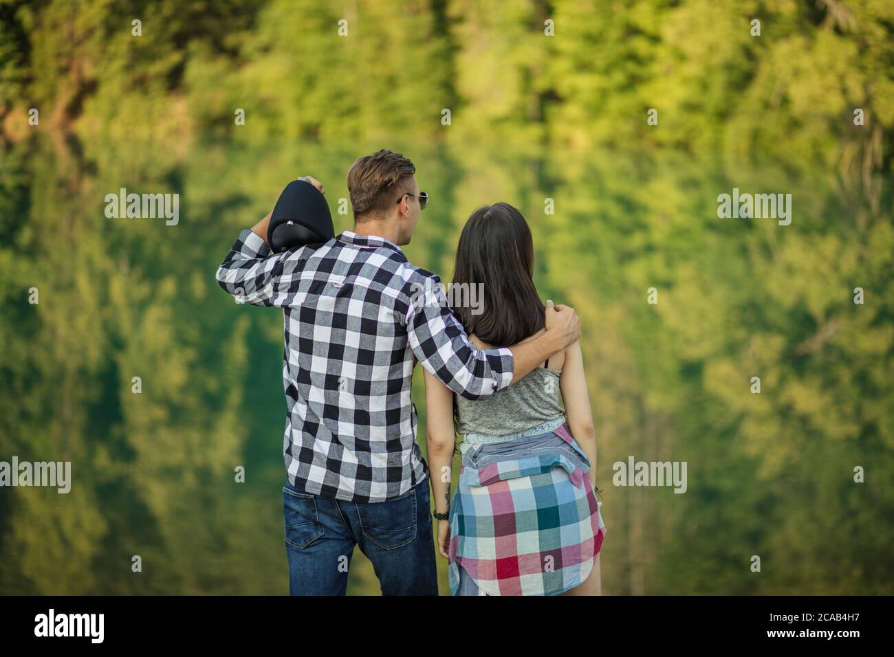 Enamored Couple Are Looking At The Green Trees Recreation On The enamored-couple-are-looking-at-the-green-trees-recreation-on-the