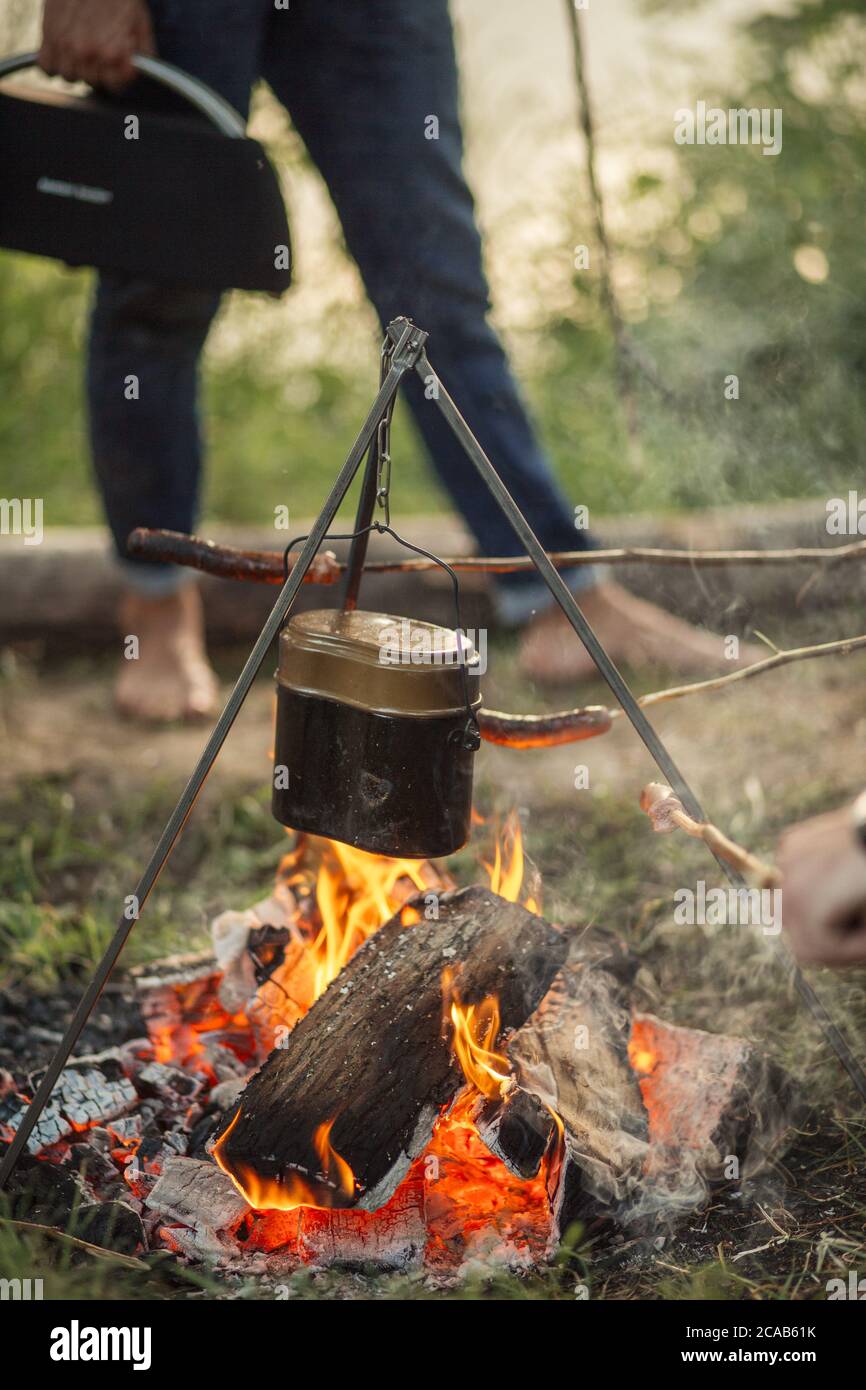 Campfire kettle closeup with blurred bonfire in the background Stock Photo  - Alamy