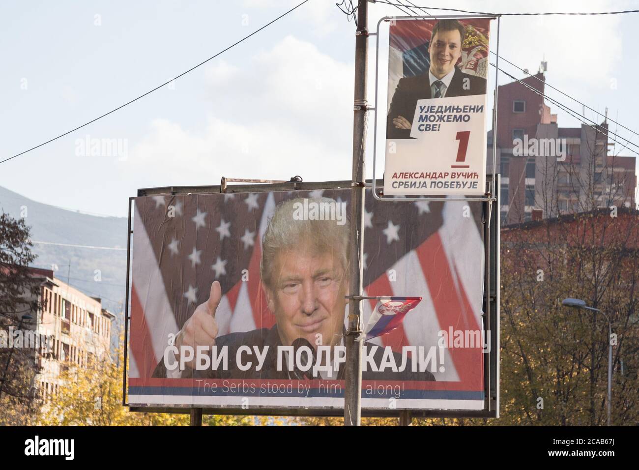 MITROVICA, KOSOVO - NOVEMBER 11, 2016: Serbian poster supporting Donald Trump near a potrait of the Serbian former Prime Minister and now president, A Stock Photo