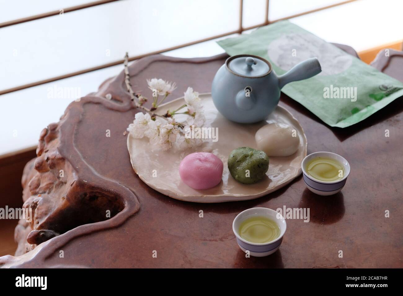 Green tea with Japanese dessert Dango during sakura season. Dessert plating with japanese traditional background. Stock Photo