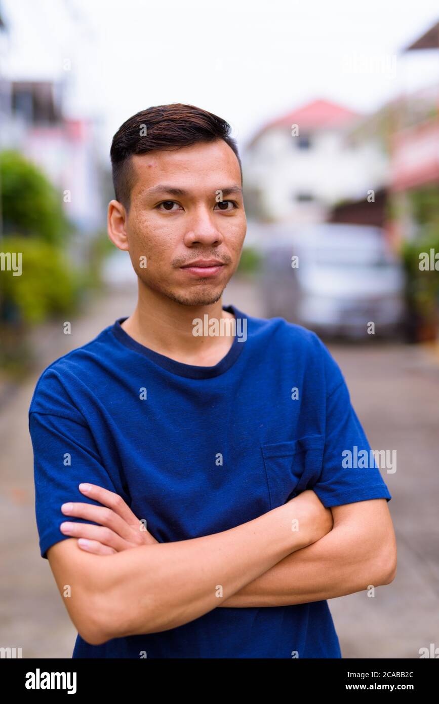 Young Asian man in the streets outdoors Stock Photo