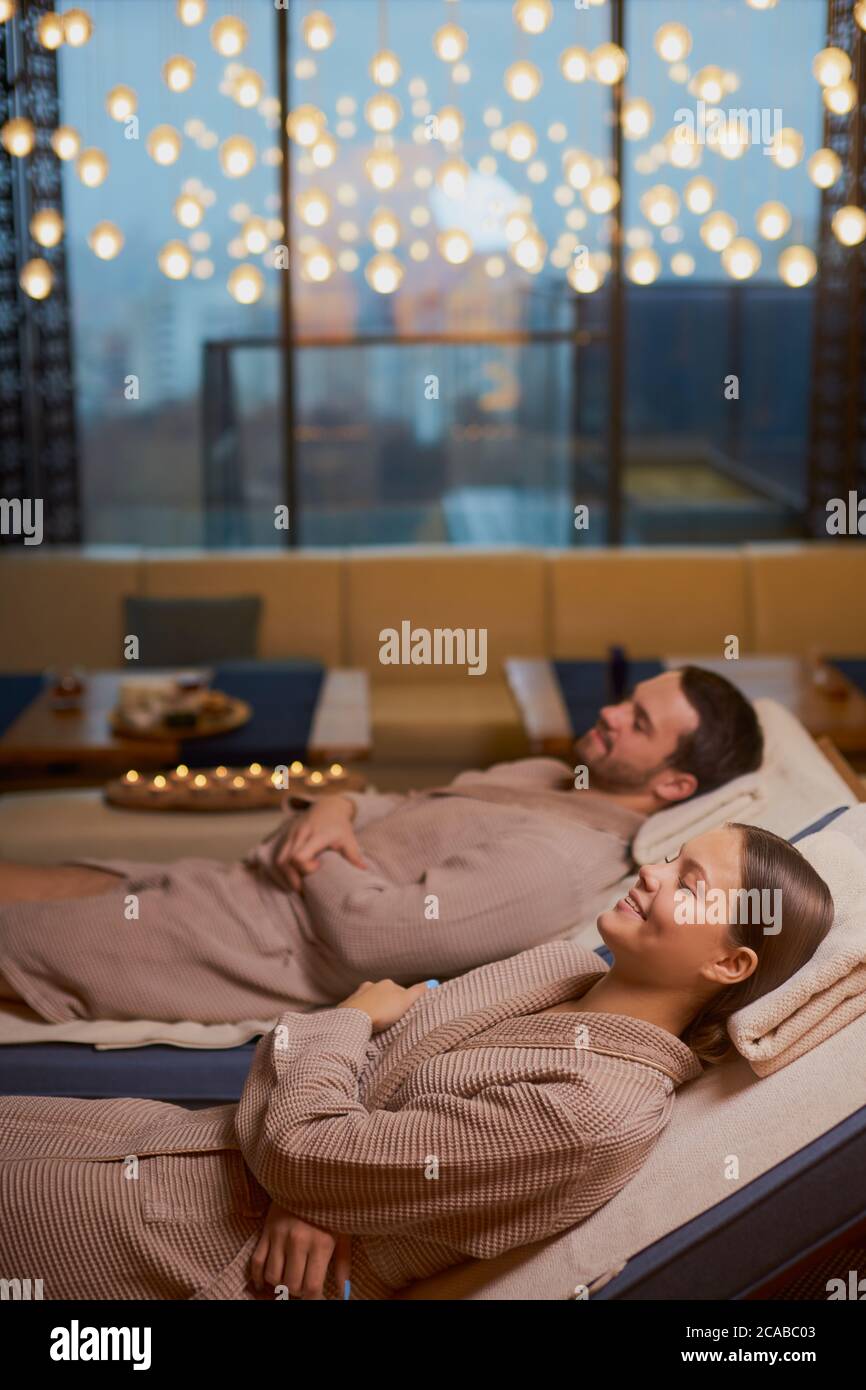 weekends of young, cute happy couple taking rest together in spa salon