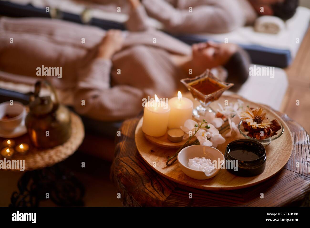 Caucasian male and female at spa procedures relax and drink tea while ...