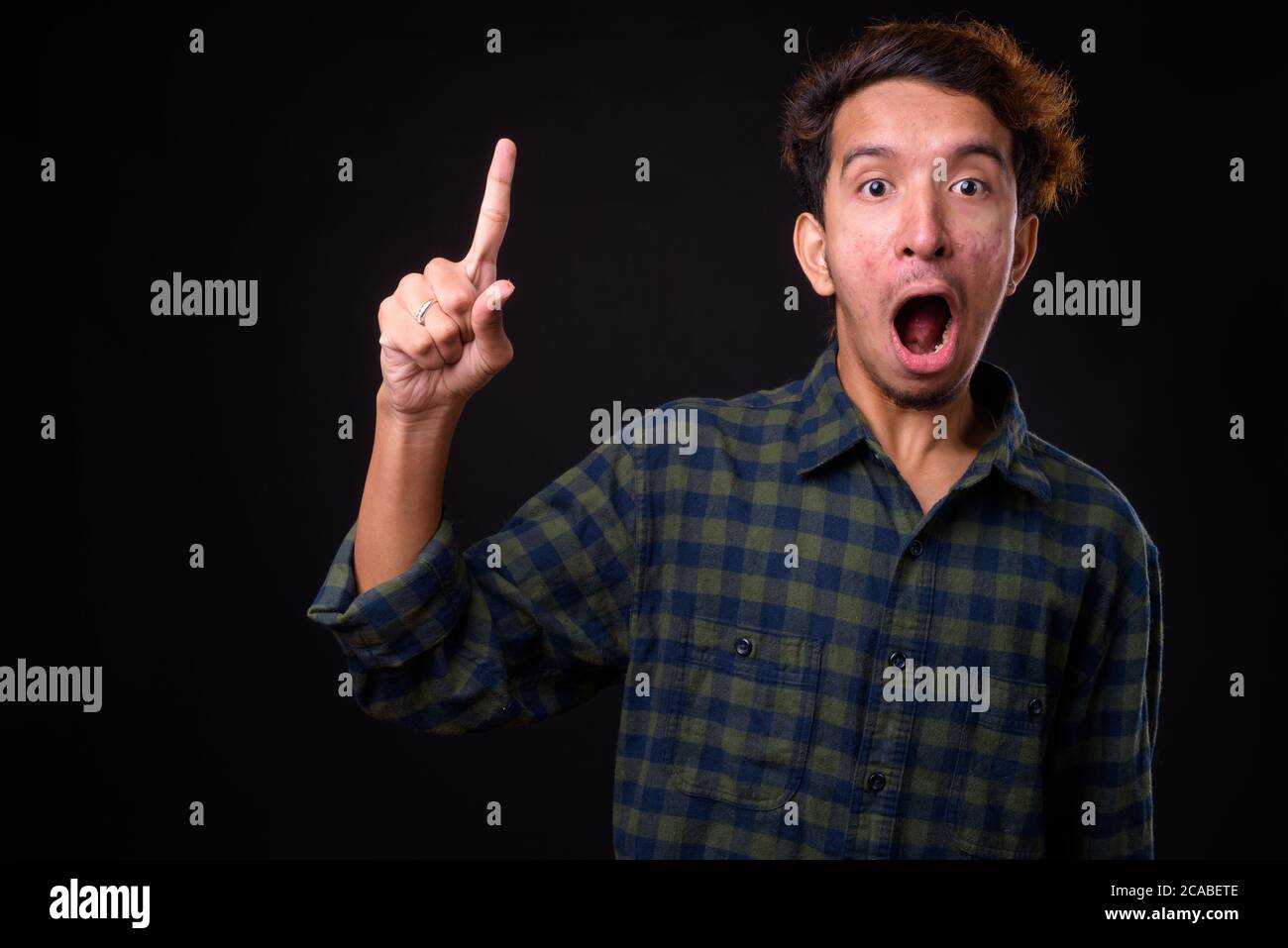 Shocked young man curly hair hi-res stock photography and images - Alamy