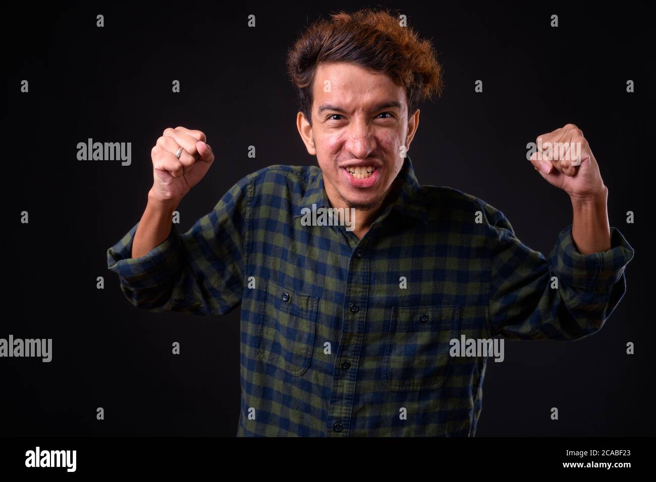 Angry young man curly hair hi-res stock photography and images - Alamy