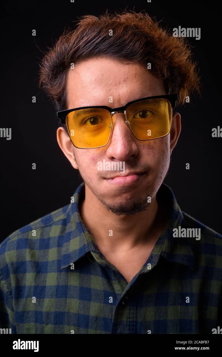 Portrait of young Asian hipster man with curly hair Stock Photo
