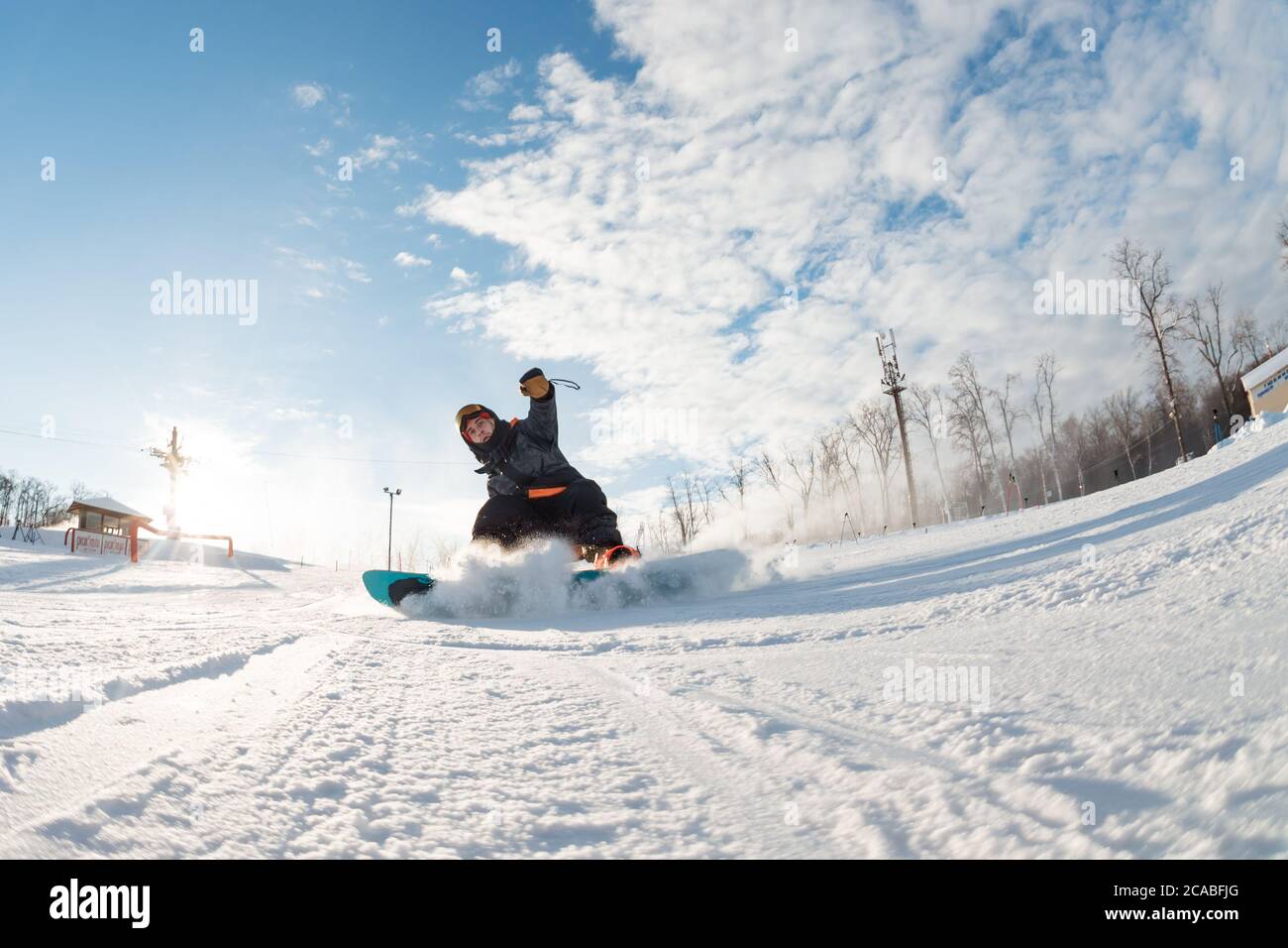 fearless snowboarder is riding fast. full length photo. photo in action