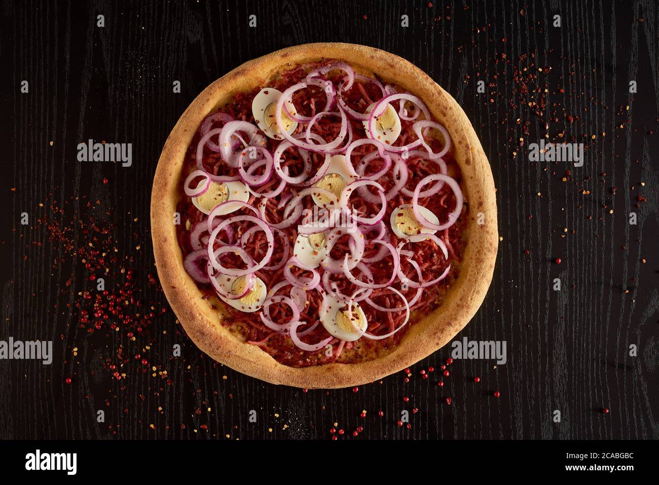 onion, eggs and pepperoni pizza on black background isolated Stock Photo