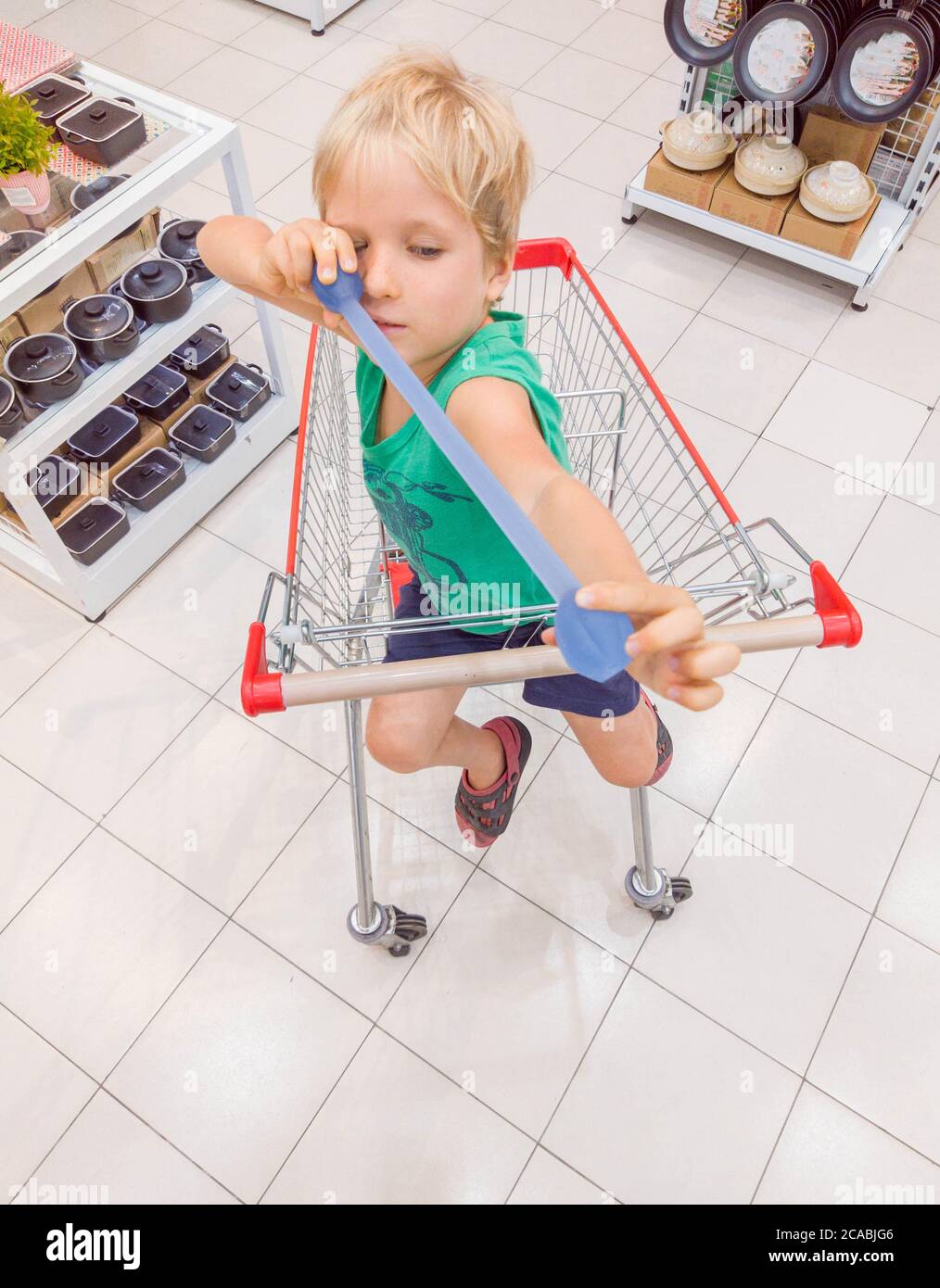 Happy smiling child sitting in trolley cart having fun Stock Photo - Alamy