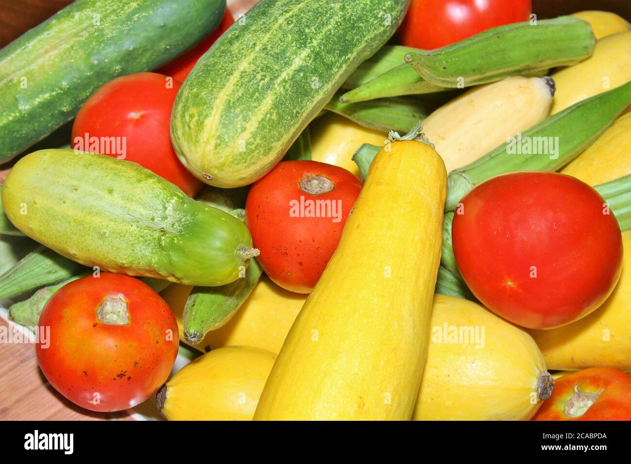 Summer vegetables, cucumbers, squash, okra and tomatoes Stock Photo