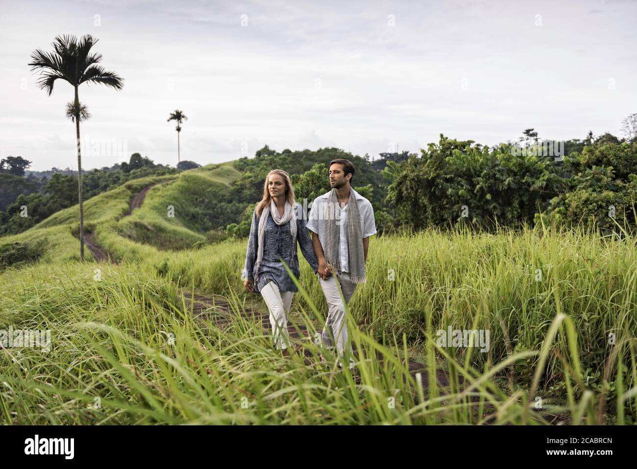 Asia, Indonesia, Bali, young Caucasian couple, wearing smart casual clothing, enjoying a walk along the famous Campuan ridge, one of the well known to Stock Photo