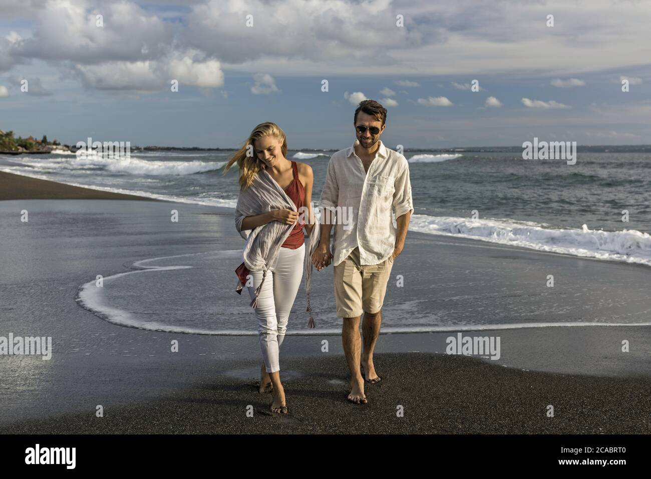 Smart couple holding hands hi-res stock photography and images - Alamy