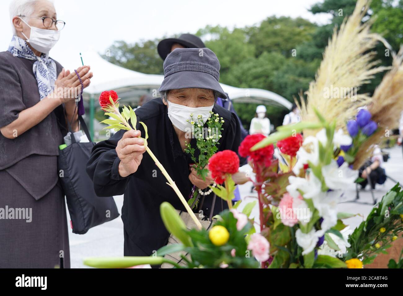 An elderly woman lays flowers at the Hiroshima Peace Memorial Ceremony.Hiroshima marks the 75th anniversary of the U.S. atomic bombing which killed about 150,000 people and destroyed the entire city during World War II. Stock Photo