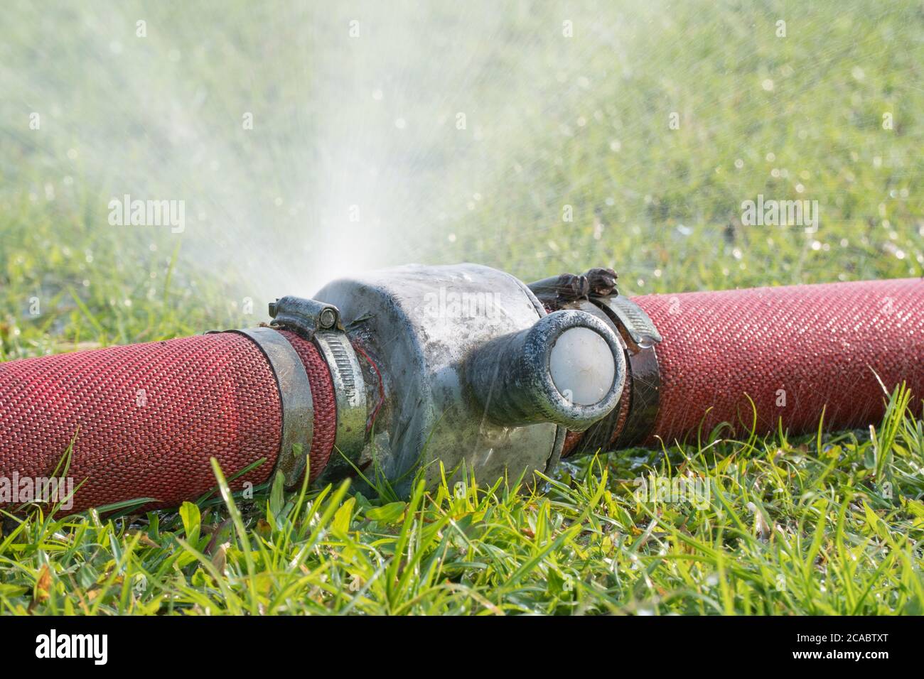 water leaking from hole in a industrial hose Stock Photo Alamy