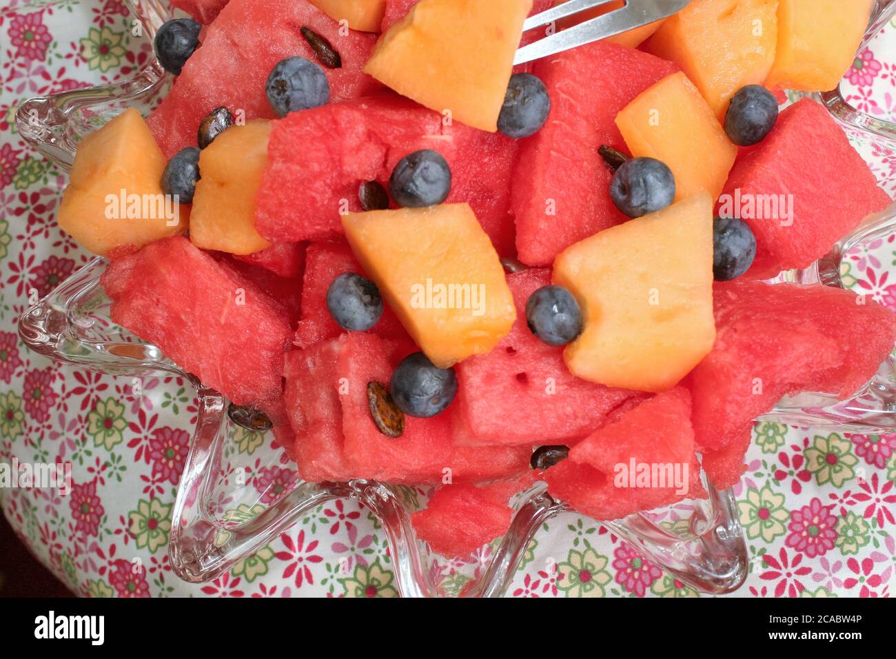 Cantaloupe, watermelon and blueberries in a glass dish Stock Photo