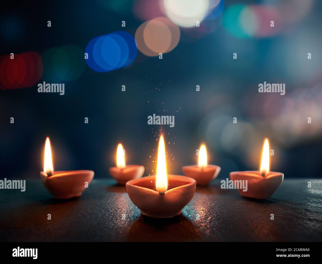 Happy Diwali, Lit diya lamp on an abtract background with shallow depth of field Stock Photo