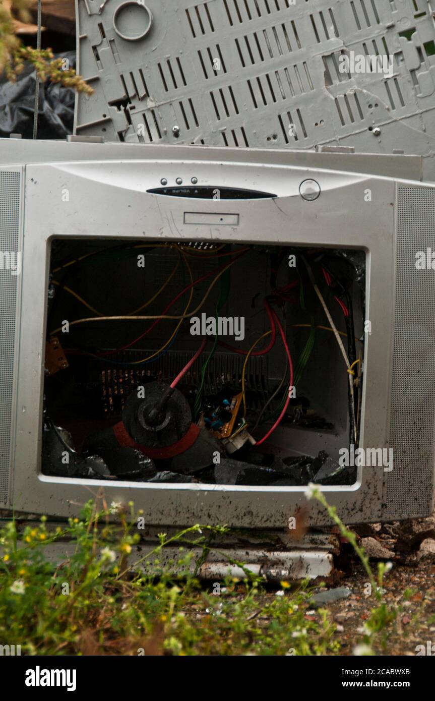 broken computer monitor abandoned with other electronic garbage Stock