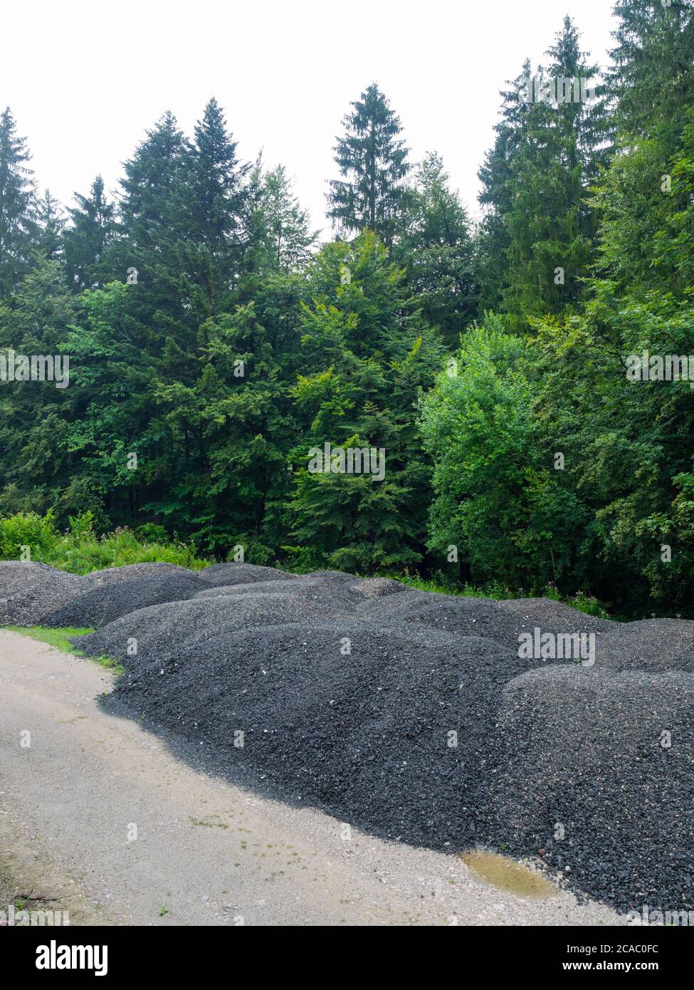 Piled asphalt in natural environment for further road construction Stock Photo