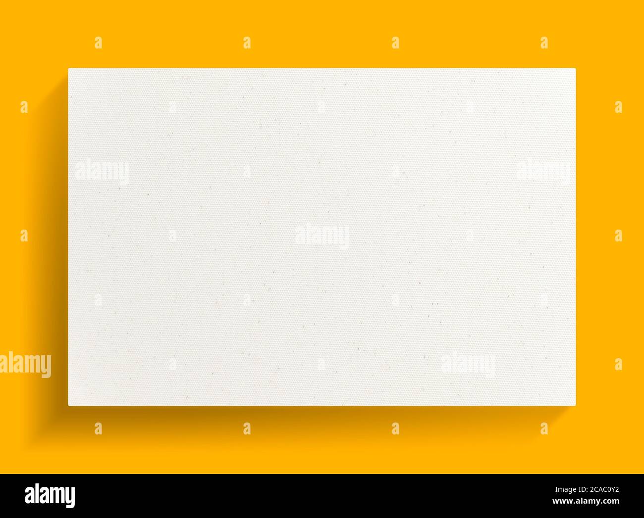 White canvas frame on yellow background with soft shadow. Stock Photo