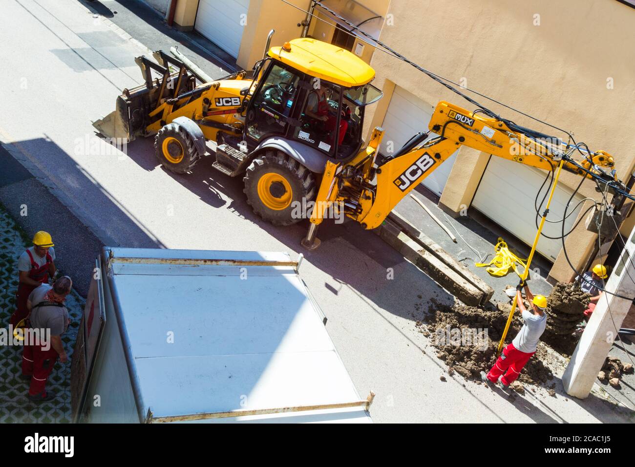 Process of installing new concrete electricity pylon in the street, Hungary, Europe Stock Photo