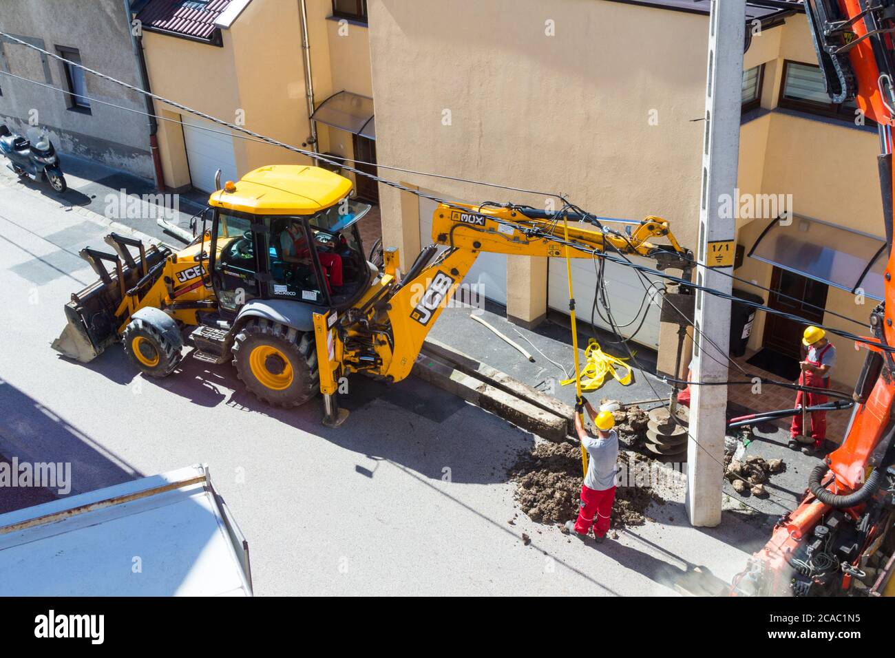 Process of installing new concrete electricity pylon in the street, Hungary, Europe Stock Photo