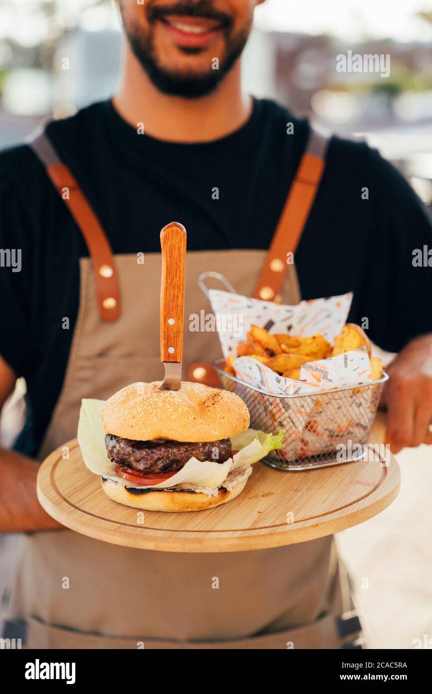 Waiter holding fast food tray hi-res stock photography and images - Alamy