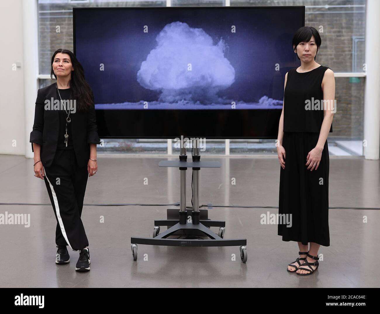 Artists Es Devlin (left) and Machiko Weston pose next to their digital art collaboration 'The End of the World', which has been commissioned by the Imperial War Museum London to mark the 75th anniversary of the bombings of Hiroshima and Nagasaki. Stock Photo