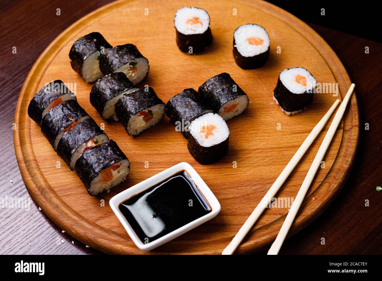 Sushi with salmon. Soy sauce, red caviar. Sushi on a black background. Stock Photo