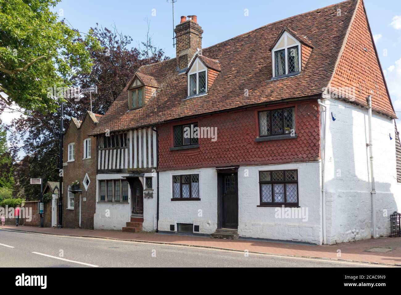 EAST GRINSTEAD,  WEST SUSSEX/UK - AUGUST 3 : Ye Olde Lock Up and Windsor Cottage in the High Street East Grinstead West Sussex on August 3, 2020. Two unidentified people Stock Photo