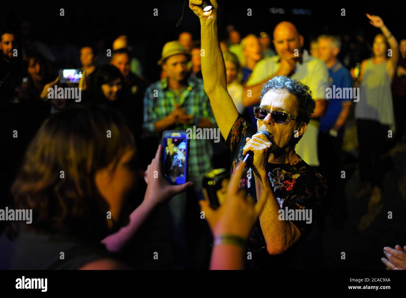 Winton Raceway, Victoria. 25th March 2017. Pictured: Mark Gable of Australian rock band The Choirboys is filmed on a phone by a fan. Gable jumped into Stock Photo
