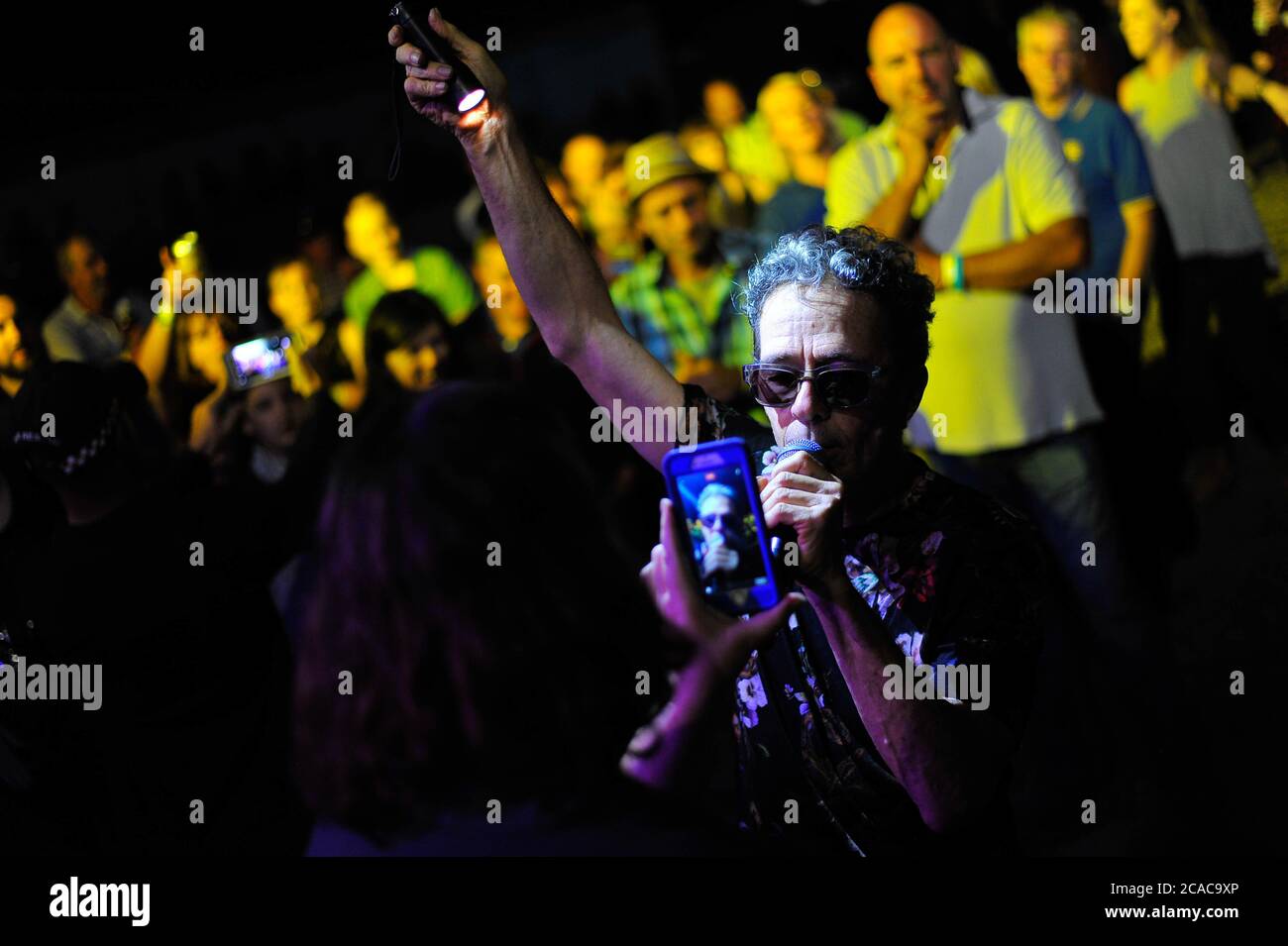 Winton Raceway, Victoria. 25th March 2017. Pictured: Mark Gable of Australian rock band The Choirboys is filmed on a phone by a fan. Gable jumped into Stock Photo