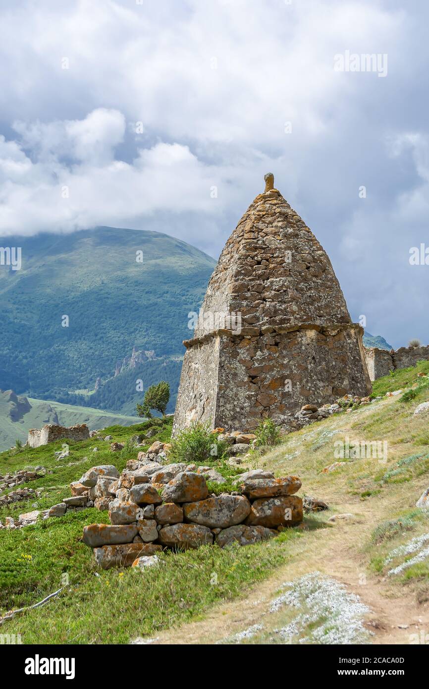 Medieval tomb in the background of the cloudy sky in City of Dead near Eltyubyu, Kabardino-Balkaria, Russia. Stock Photo