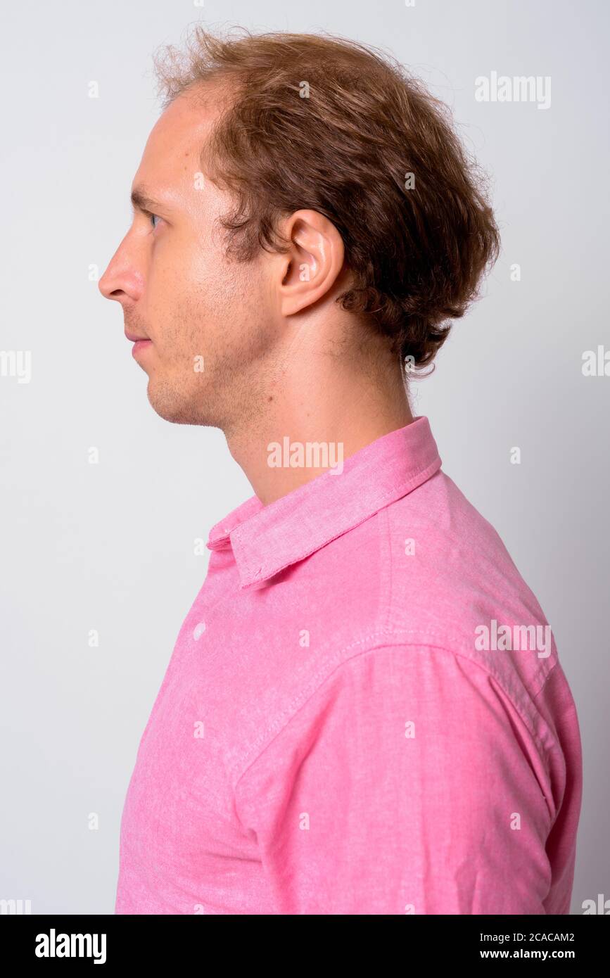 Portrait of businessman with blond hair wearing pink shirt Stock Photo