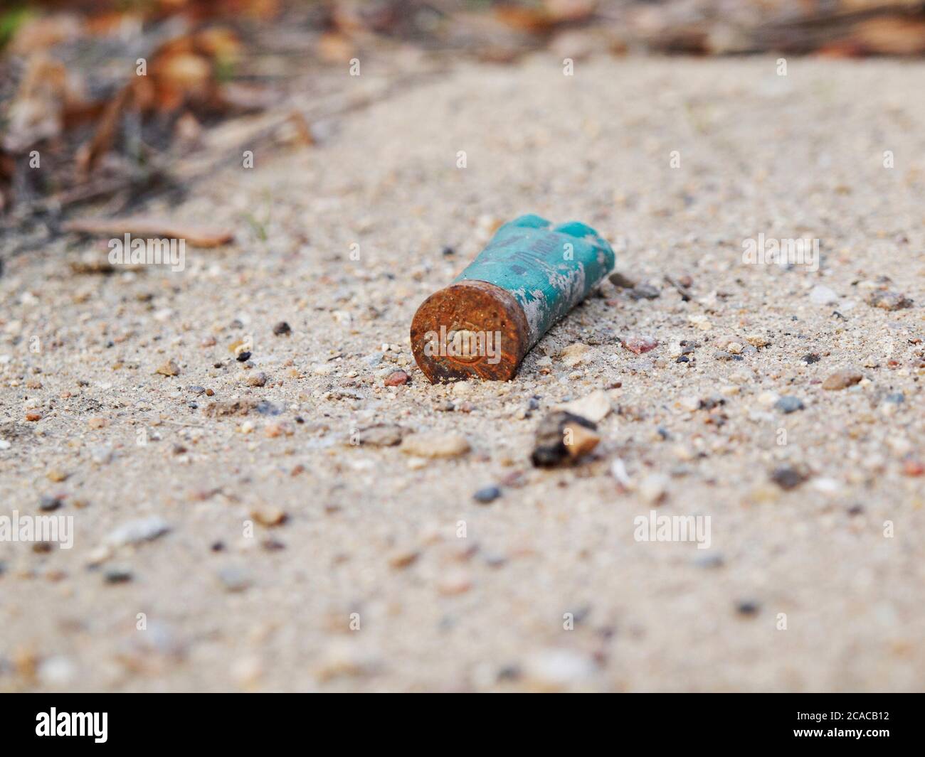 Empty old cartridge case from a rifle cartridge on the road Stock Photo