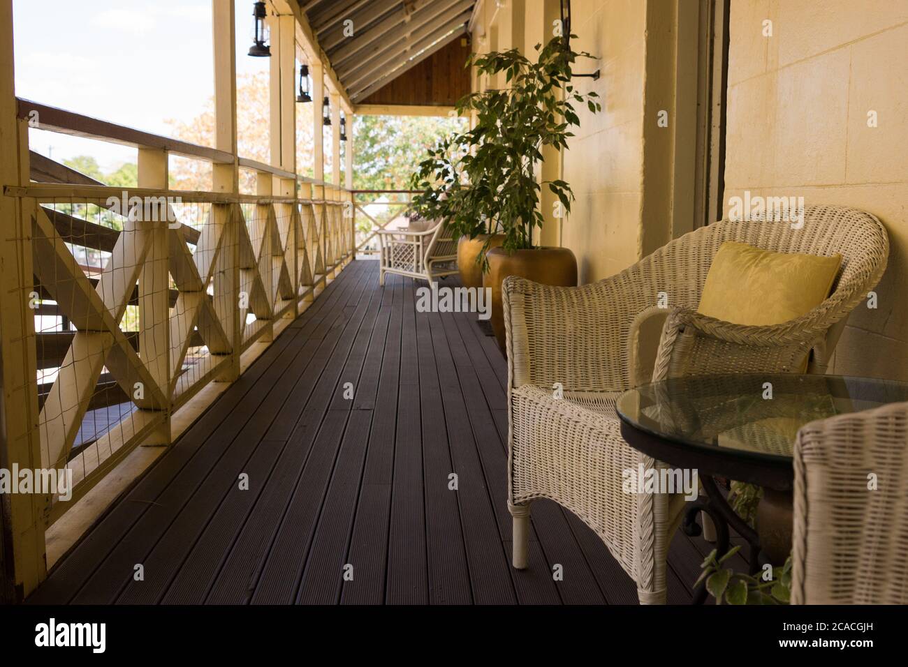 Cane chairs and table on timber verandah of Queenslander style house, Australia Stock Photo