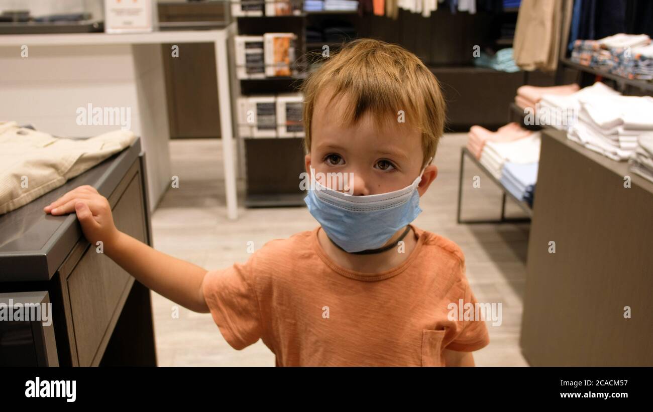Child in a protective mask in a store Stock Photo