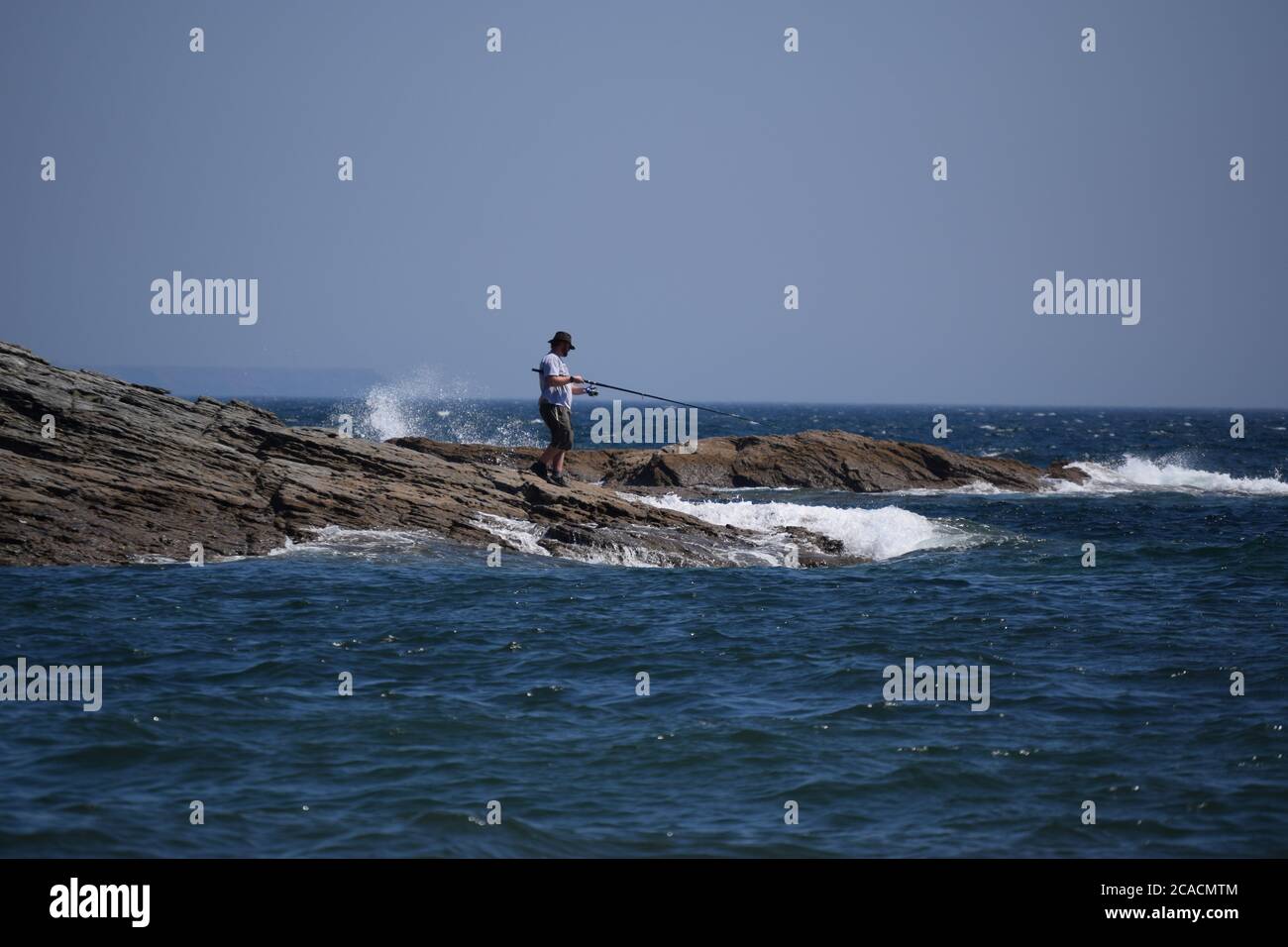 Man sea fishing from rocks hi-res stock photography and images - Alamy