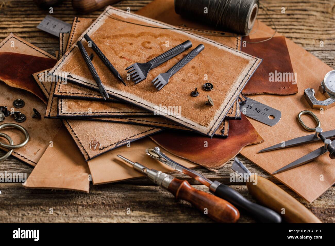 Leather craft tools on old wood table. Leather craft workshop Stock Photo -  Alamy
