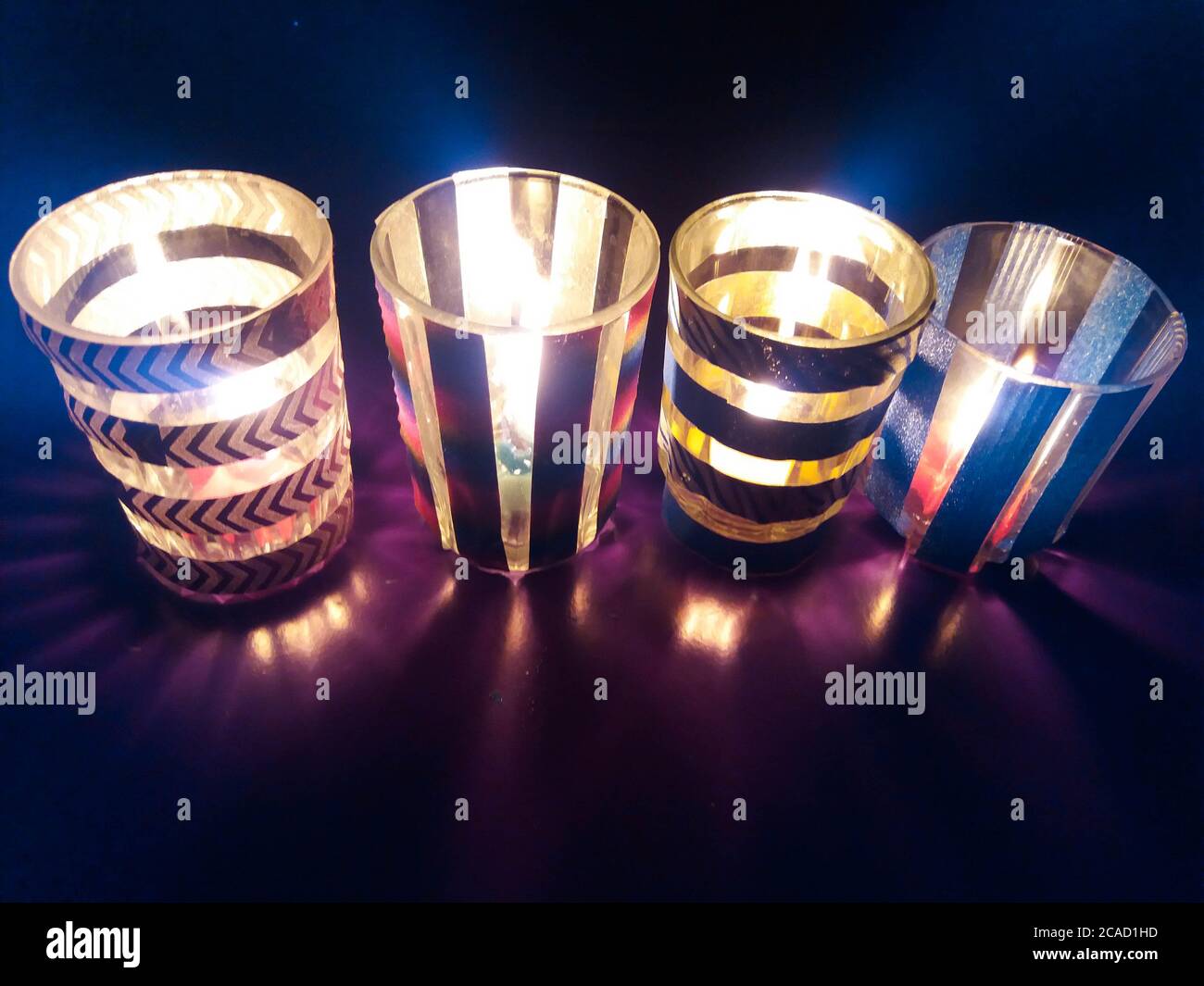 Colorful homemade candle holders with washi tape and glass, DIY home  decoration Stock Photo - Alamy