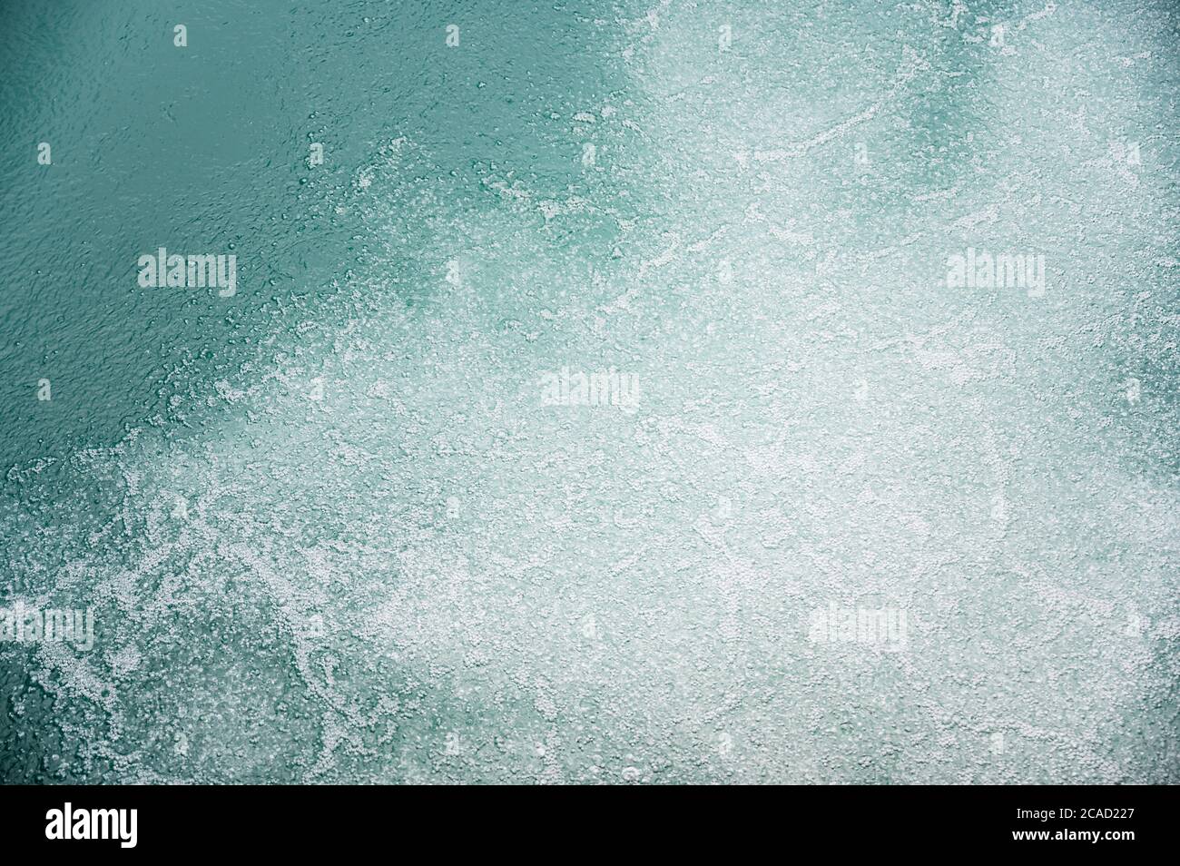 white air bubbles in turquoise water of Lake Brienz Stock Photo